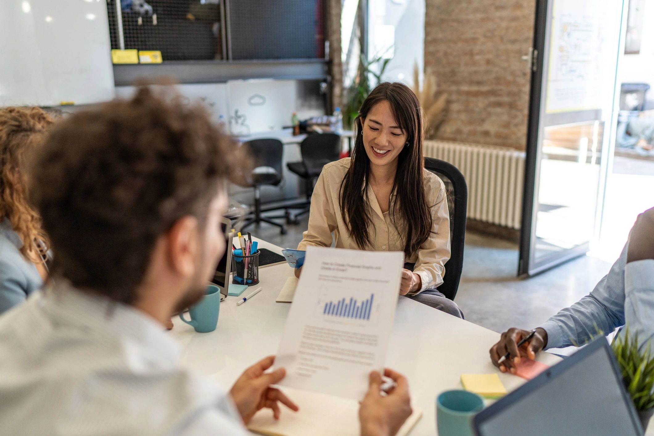 Team of financial analysts collaborating at computer screens